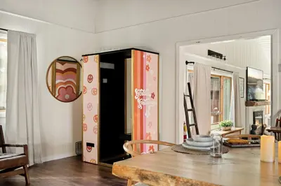 a dining room with a table and a mirror at The Willow Cabin in Big Bear Lake