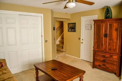 a living room with a ceiling fan and a wooden table at Arrowhead Cabin Near Lake and Village in Lake Arrowhead