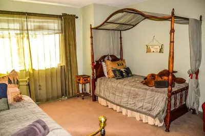 a bedroom with a canopy bed with a dog laying on it at Arrowhead Cabin Near Lake and Village in Lake Arrowhead