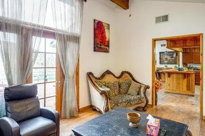 a living room with a chair and a table at Private Sauna and Mtn-View Deck! Kern County Home in Pine Mountain Club