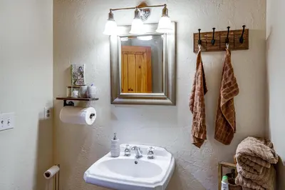 a bathroom with a sink and a mirror at Private Sauna and Mtn-View Deck! Kern County Home in Pine Mountain Club