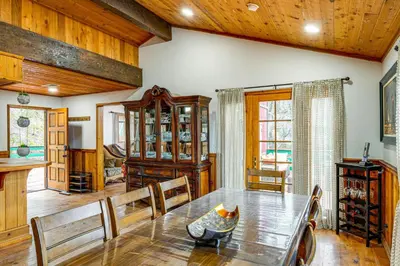 a dining room with a table and wooden ceilings at Private Sauna and Mtn-View Deck! Kern County Home in Pine Mountain Club