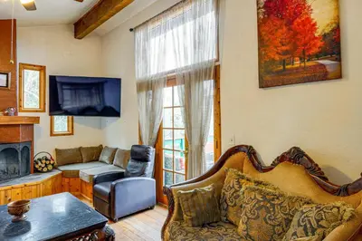 a living room with a couch and a fireplace at Private Sauna and Mtn-View Deck! Kern County Home in Pine Mountain Club
