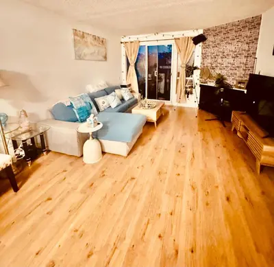 a living room with a couch and a wooden floor at Sweet 2 bedrooms home by the beach city in Los Angeles