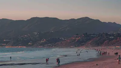 a group of people on a beach near the water at Sweet 2 bedrooms home by the beach city in Los Angeles