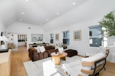 a living room with couches and a table at Modern Mid-Wilshire Escape Prime Spot in Los Angeles