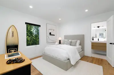 a white bedroom with a bed and a mirror at Modern Mid-Wilshire Escape Prime Spot in Los Angeles