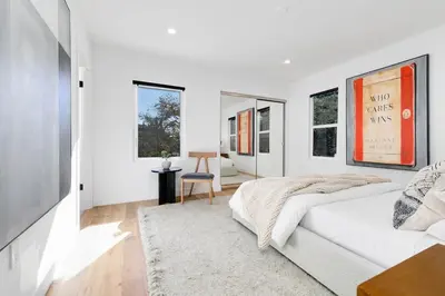 a white bedroom with a bed and a rug at Modern Mid-Wilshire Escape Prime Spot in Los Angeles