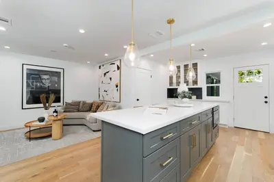 a kitchen and living room with a table and a couch at Modern Mid-Wilshire Escape Prime Spot in Los Angeles