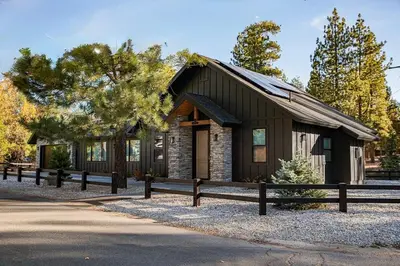 a small house with a fence in front of it at Bearadise, LuxuryNew Build, Central, Hot Tub, EV ,Games in Big Bear Lake