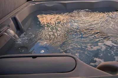 a bath tub filled with water in a boat at Bearadise, LuxuryNew Build, Central, Hot Tub, EV ,Games in Big Bear Lake