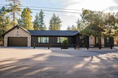 a brick house with a driveway in front of it at Bearadise, LuxuryNew Build, Central, Hot Tub, EV ,Games in Big Bear Lake