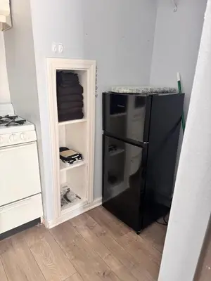 a kitchen with a black refrigerator in a room at Cozy Studio, Studio City Unit 3 in Los Angeles