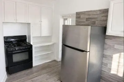 a kitchen with a stainless steel refrigerator and an oven at Hoover Homes for the Soul in Los Angeles