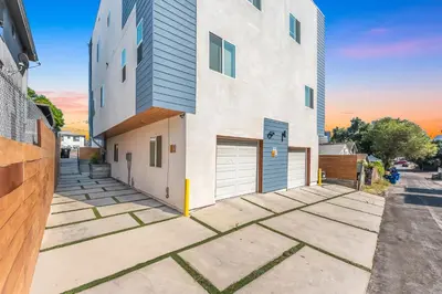 a large white building with two garage doors at Central LA Escape Near Universal & Beaches in Los Angeles
