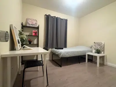 a room with a bed and a desk with a sink at Blue Urban Stay LA in Los Angeles