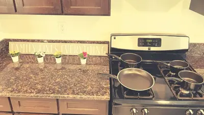 a kitchen counter with pots and pans on a stove at Blue Urban Stay LA in Los Angeles