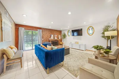 a large living room with a blue couch and chairs at Spacious 5 Bedroom Home Near Disneyland & Knotts with Jacuzzi Spa in Norwalk