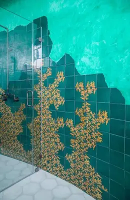 a bathroom with a glass shower with trees on the wall at Paradise De Rocas Antiguas in Los Angeles