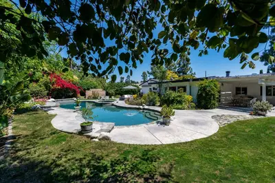 a backyard with a swimming pool and a house at Newly remodeled home w pool & private back yard in Thousand Oaks