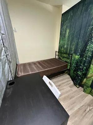 a room with two beds and a table at Shared room, Prime Location LA in Los Angeles