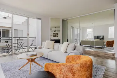 a living room with a couch and a table at Blueground Hollywood gym AC nr Runyon LAX-1344 in Los Angeles