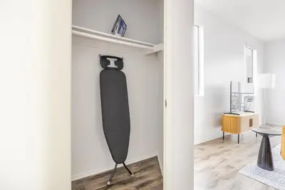 a room with a black paddle board hanging on the wall at Blueground Hollywood gym AC nr Runyon LAX-1344 in Los Angeles