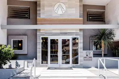 a facade of a building with a revolving door at Blueground Hollywood gym AC nr Runyon LAX-1344 in Los Angeles