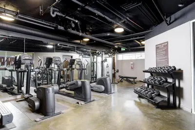 a gym with several treadmills and cardio machines at Blueground Hollywood gym AC nr Runyon LAX-1344 in Los Angeles
