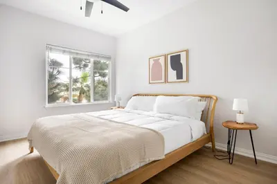 a white bedroom with a large bed and a window at Blueground Playa del Rey pool nr Dockweiler LAX-1431 in Los Angeles