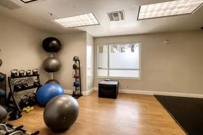 a room with a gym with exercise balls and balloons at Blueground Playa del Rey pool nr Dockweiler LAX-1431 in Los Angeles