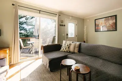 a living room with a couch and a table at Peaceful Mountain Sanctuary near Arrowhead Village in Lake Arrowhead