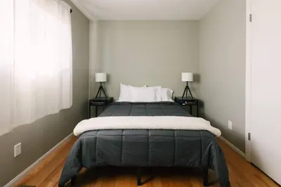 a bedroom with a large bed with two lamps at Peaceful Mountain Sanctuary near Arrowhead Village in Lake Arrowhead