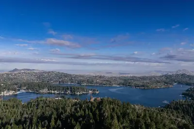 an aerial view of a lake with trees and mountains at Peaceful Mountain Sanctuary near Arrowhead Village in Lake Arrowhead