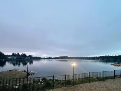 a view of a lake at dusk at Peaceful Mountain Sanctuary near Arrowhead Village in Lake Arrowhead