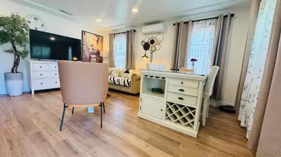 a living room with a dresser and a table and chair at Charming 2B2B Retreat in Temple City in Temple City