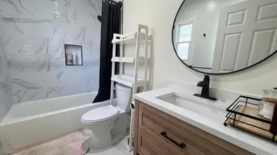 a bathroom with a toilet and a sink and a mirror at Charming 2B2B Retreat in Temple City in Temple City