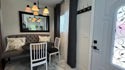 a living room with a table and chairs and a mirror at Charming 2B2B Retreat in Temple City in Temple City