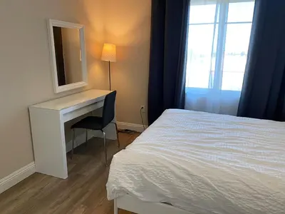 a bedroom with a bed and a desk with a mirror at Modern 2BD Apartment with 2 Baths in Alhambra in Alhambra