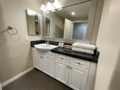 a bathroom with a sink and a mirror at Spacious 2 Bed, 2-Bath Apartment in Monterey Park in Monterey Park
