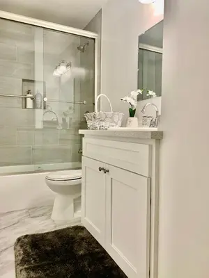 a white bathroom with a toilet and a shower at Proper Stays at Melrose - West Hollywood Premium R suite in Los Angeles