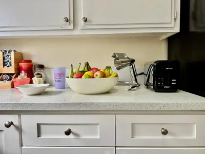 a bowl of fruit on a counter in a kitchen at Proper Stays at Melrose - West Hollywood Premium R suite in Los Angeles