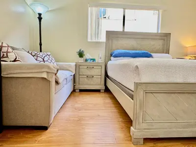 a bedroom with two beds next to a window at Proper Stays at Melrose - West Hollywood Premium R suite in Los Angeles