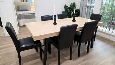 a dining room table with black chairs around it at Renovated Three Bedroom Near Cedars Sinai and Beverly Hills With Parking in Los Angeles