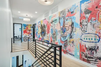 a mural on the wall of a building with a staircase at Hollywood Hills Luxury Nest Views Pool Spa in Los Angeles