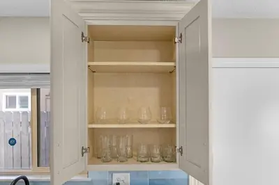 a cupboard filled with glasses in a kitchen at Near LLU Hospital Calm 3BR Workspace in Loma Linda