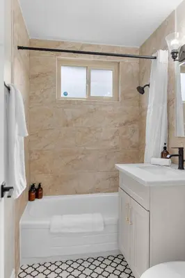 a white bathroom with a tub and a sink at Near LLU Hospital Calm 3BR Workspace in Loma Linda