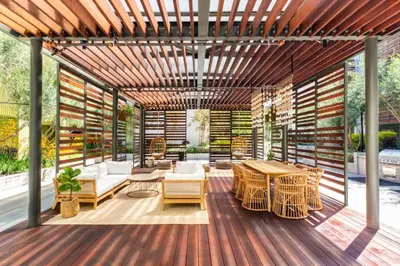 a wooden pergola with a table and chairs on a deck at Runway Playa Vista in Los Angeles