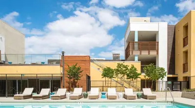 a pool with lounge chairs and a building at Runway Playa Vista in Los Angeles