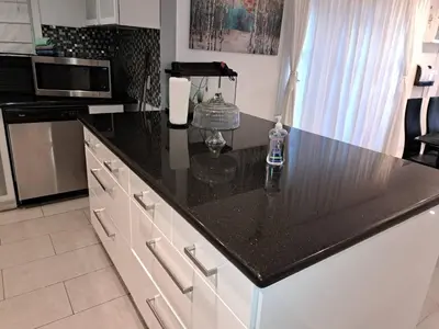 a kitchen with a black counter top and a microwave at Amazing 3 bedrooms with 3 bedroom apt in the center of Beverly Hills in Los Angeles